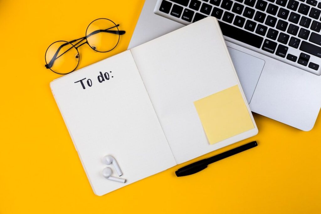 Home office desk workspace with laptop on yellow background. Flat lay, top view girl boss work business concept. Work at home concept on coronavirus quarantine