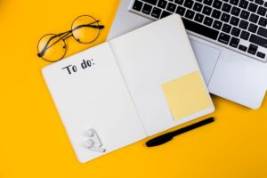 Home office desk workspace with laptop on yellow background. Flat lay, top view girl boss work business concept. Work at home concept on coronavirus quarantine